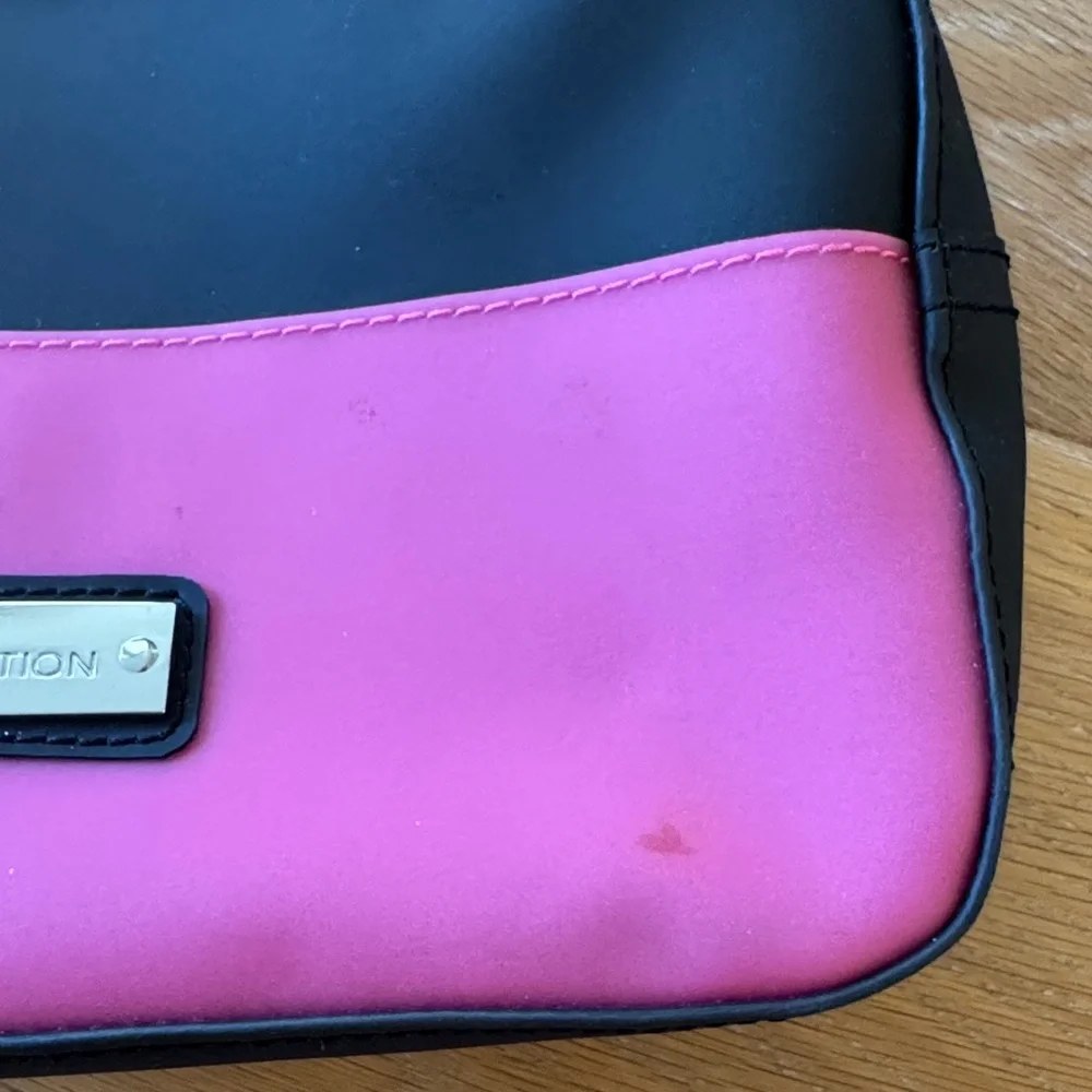 BCBGeneration plastic zippered cosmetic case pink black